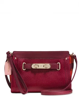 Coach Rogue bags with a monogram - embossed leather surfaceCoach Swagger Wristlet in Colorblock Pebble Leather