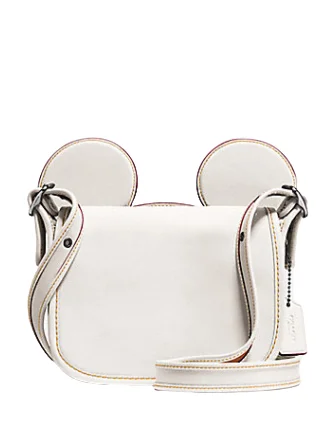 Coach tote bags with a snap - button closure and a decorative charm for styleCoach Patricia Saddle in Glove Calf Leather With Mickey Ears