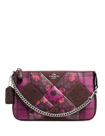 Coach Rogue bags featuring the signature C - hardware for a branded lookCoach Nolita Wristlet 24 in Patchwork Print Leather