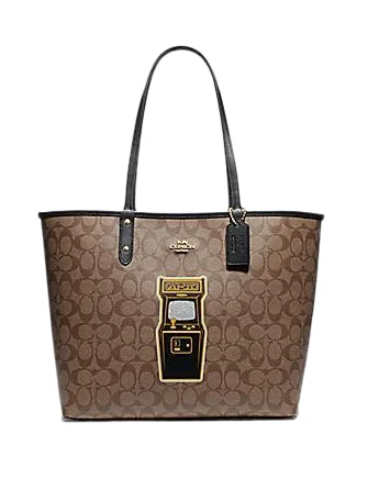 Coach Rogue bags with a monogram - embossed leather surfaceCoach Reversible City Tote in Signature Canvas With Pac Man Game