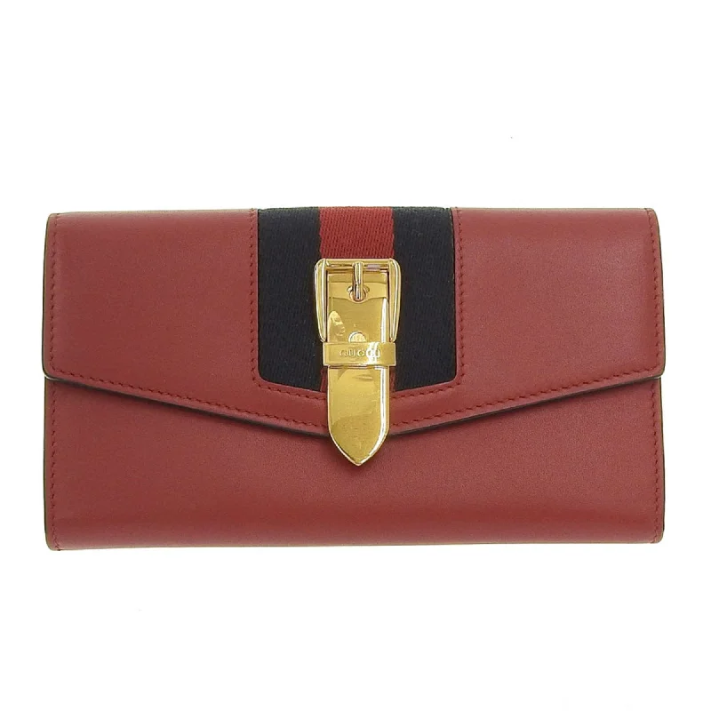 Women Gucci bags with a snap - button closure and a decorative charmWomen Gucci bags with a snap - button closure and a decorative charmGucci continental wallet with hook long leather canvas red navy blue 476084